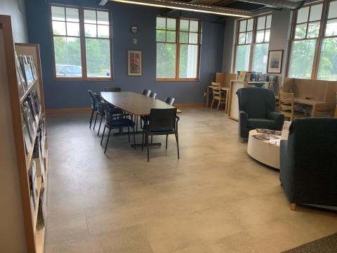 Magazine Lounge with a table and eight chairs, plus two study carrels and three armchairs