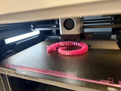 Pink water dragon being 3D printed