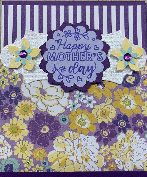 card with gold and purple flowers and a small blue label that reads Happy Mothers' Day